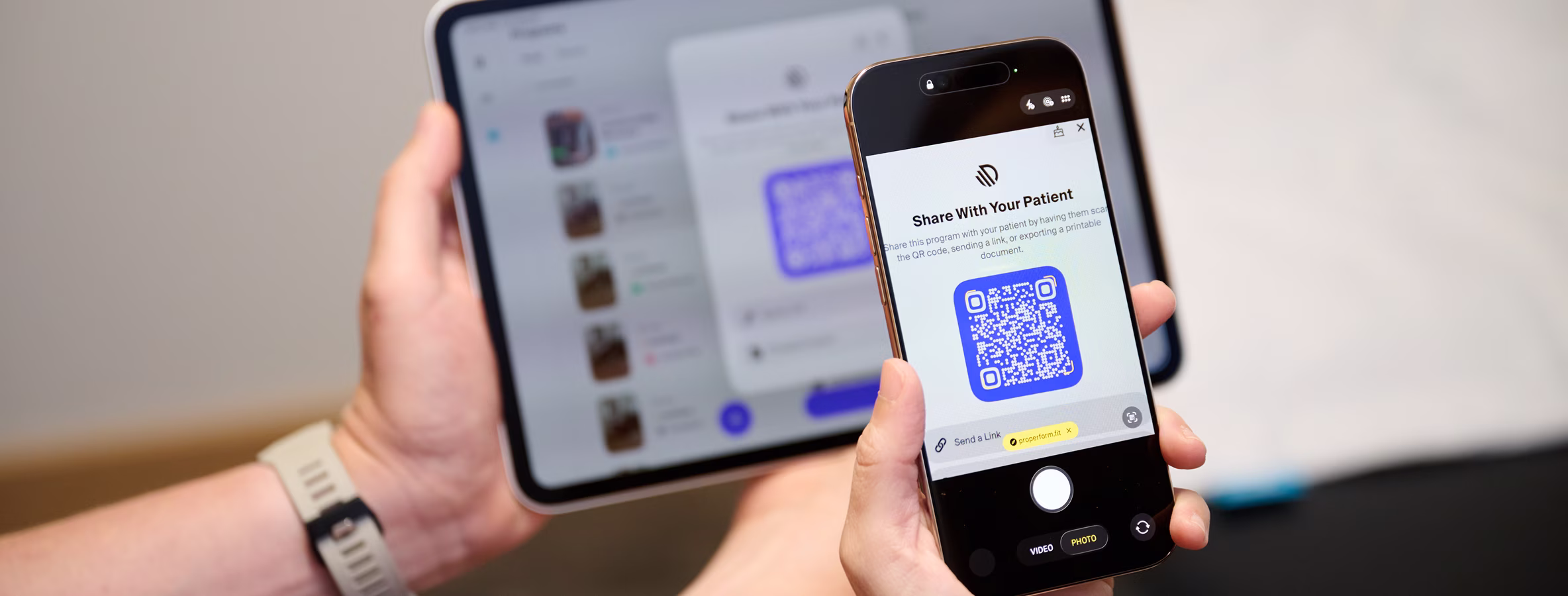 Patient scanning a QR code on a tablet to receive their home exercise program
