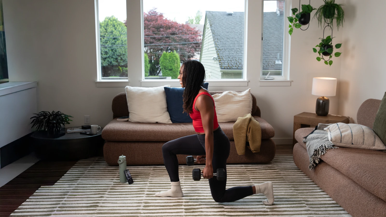 Athlete doing lunges at home with their ProperForm program