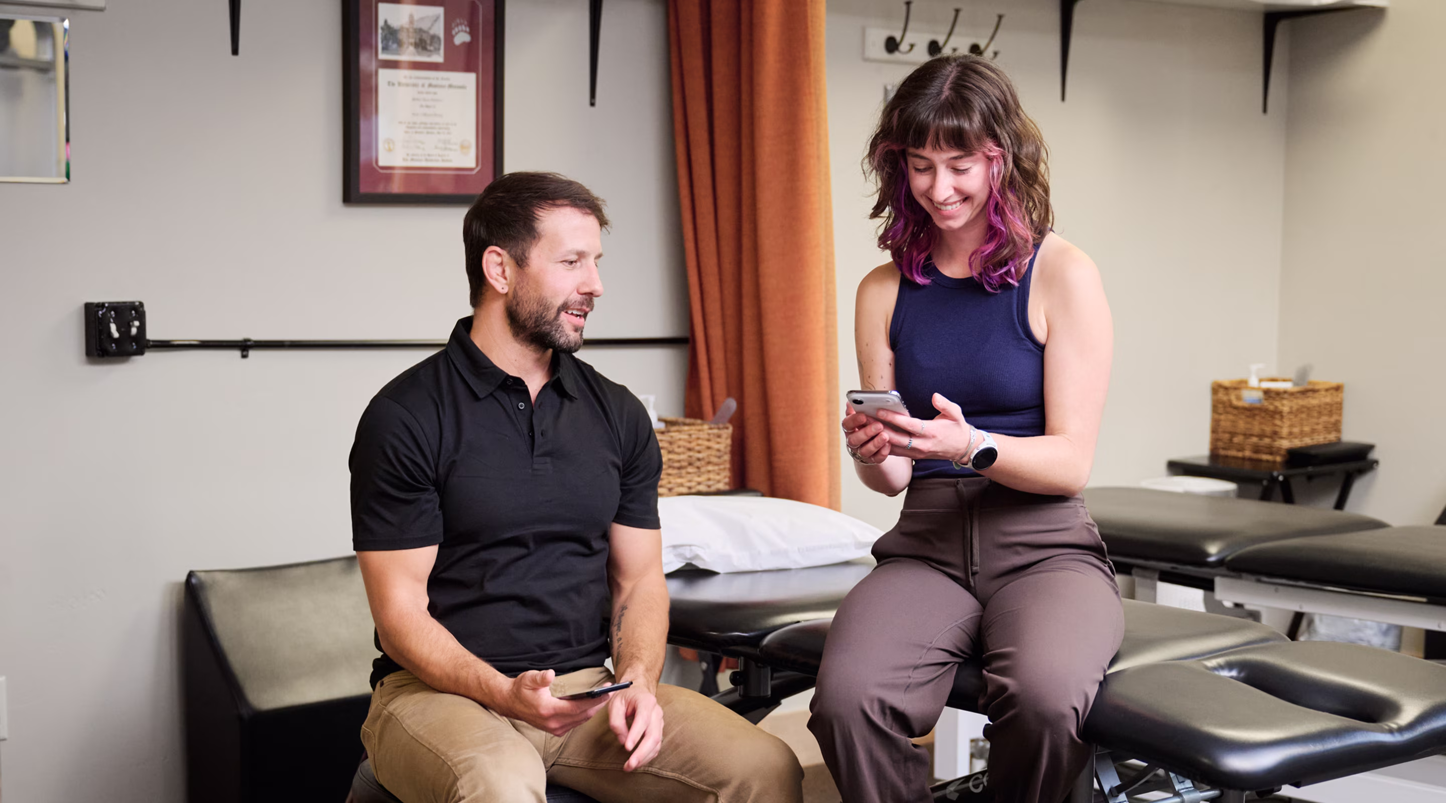 Cole with a patient as she looks at her ProperForm program on her phone